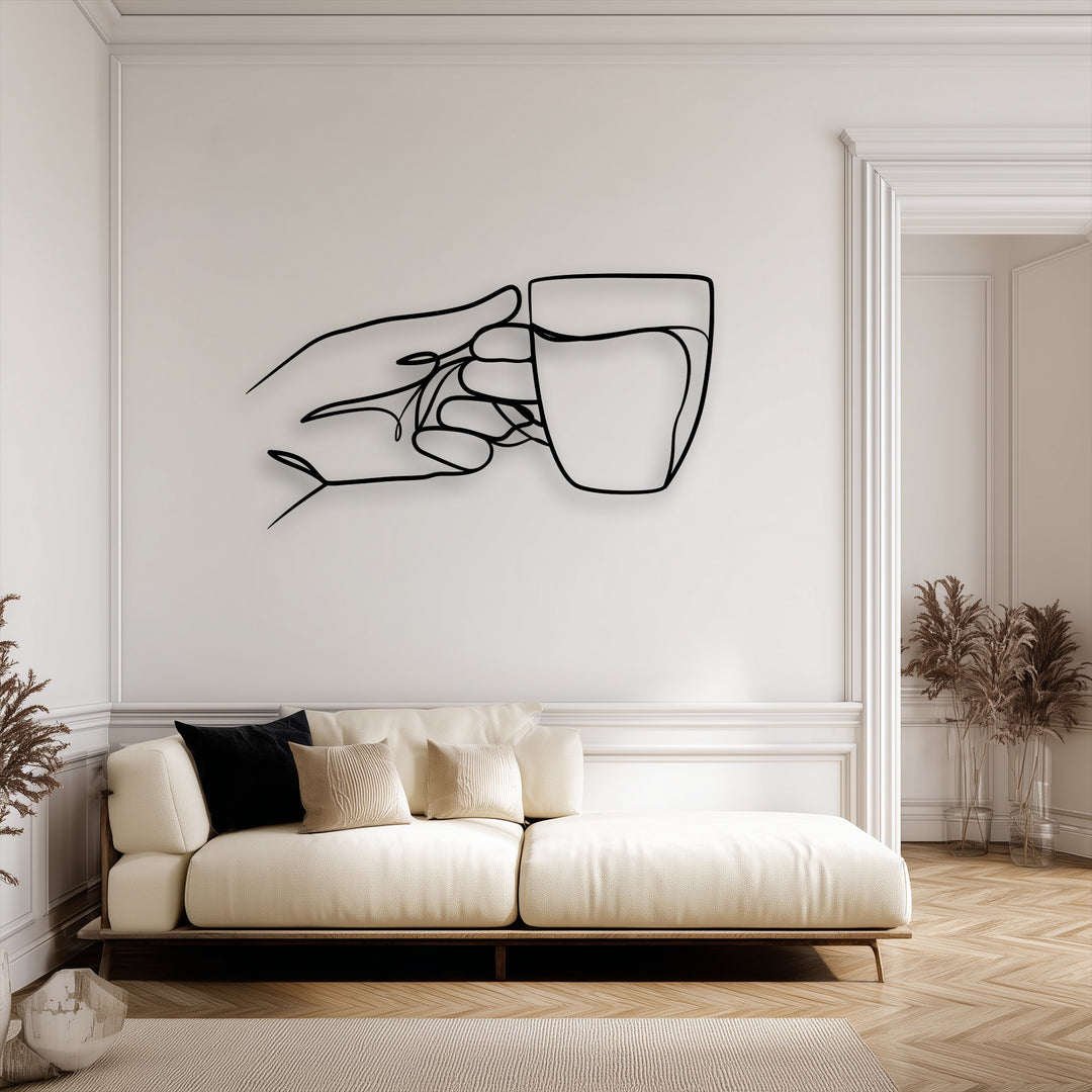 The realistic detail of this elegant minimalist hand holding cup line art metal decoration wall art stands out against the clean white wall.