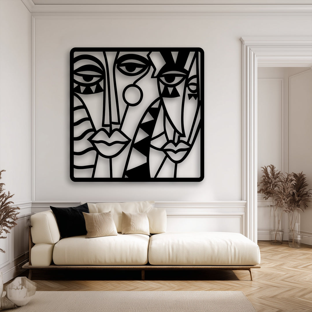 The muted color saturation highlights the striking black decorative metal art of abstract faces against the light, elegant room.