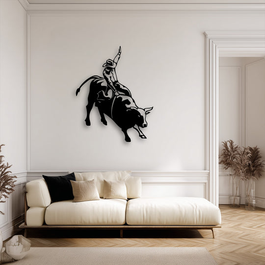 The robust black finish of this unique metal wall art featuring a rodeo cowboy on a bucking bull showcases its superior material quality.