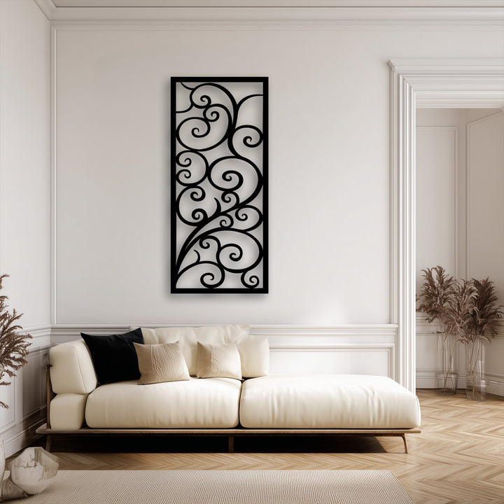 Negative space highlights the intricate scroll pattern of the black metal art for wall, contrasting beautifully with the bright white wall.