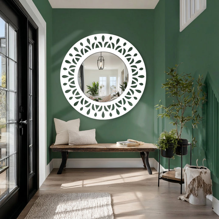 Painted green background complements the leaf motif round floor mirror, adding a modern touch to the room's interior, enhancing its wall decor.