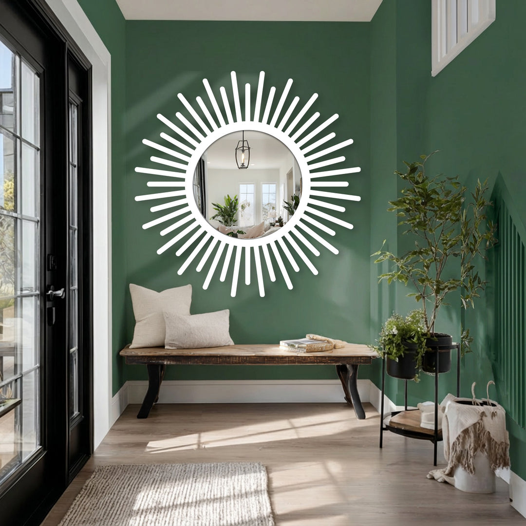 Smooth, reflective surface texture accentuates this sunburst decorative mirror, hung above a rustic wooden bench with neutral pillows and a potted plant.