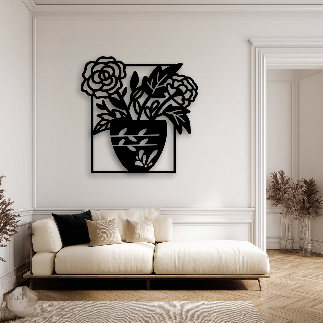 The unique metal wall art exhibits a striking layering effect, with its detailed floral vase silhouette creating depth against the light wall.