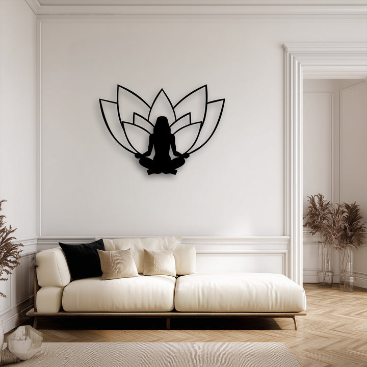 Creamy off-white walls and sofa highlight a striking black lotus meditation silhouette metal artwork in a serene interior.