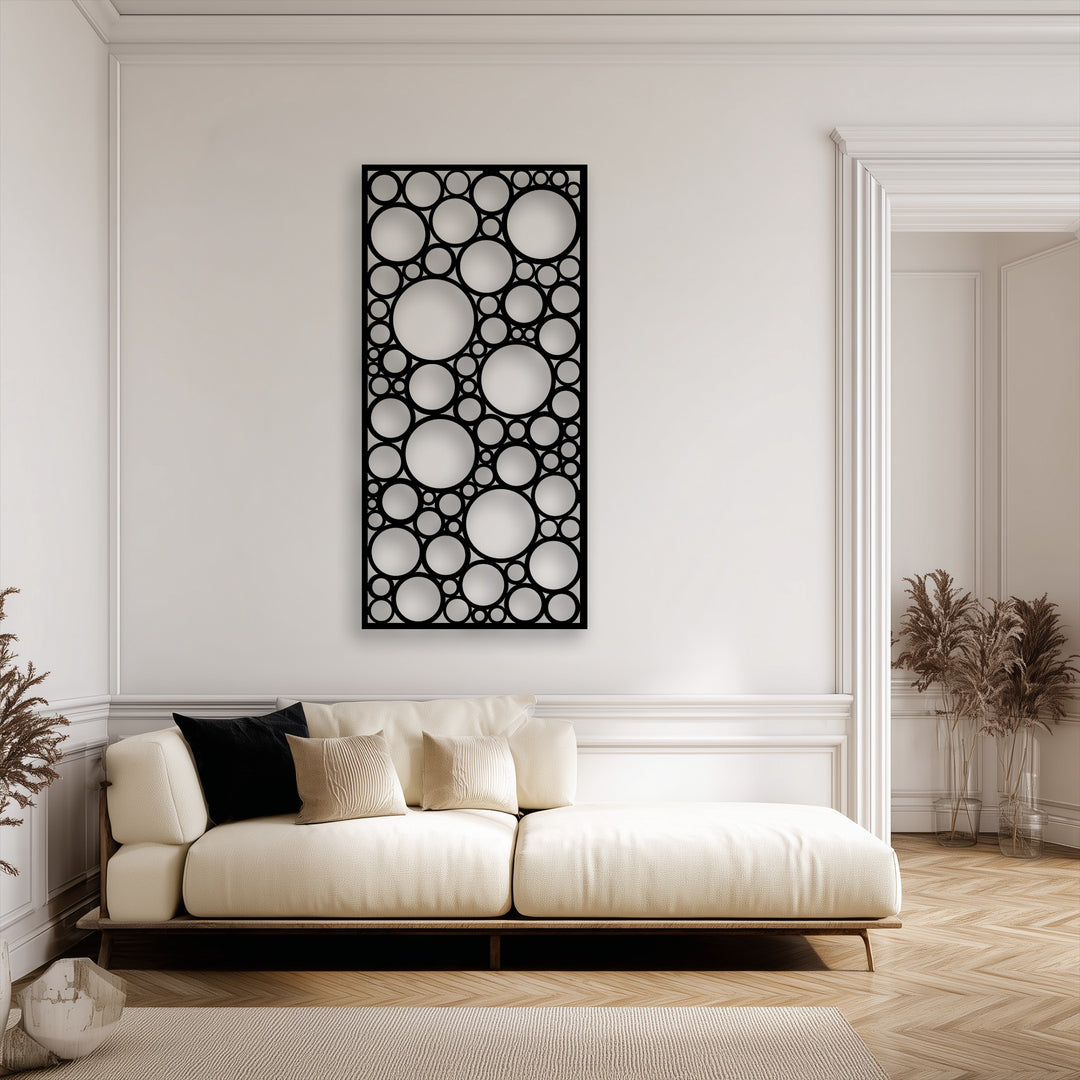 The decorative metal art, a geometric circle pattern panel, creates a playful sense of movement with its overlapping, varying sizes.