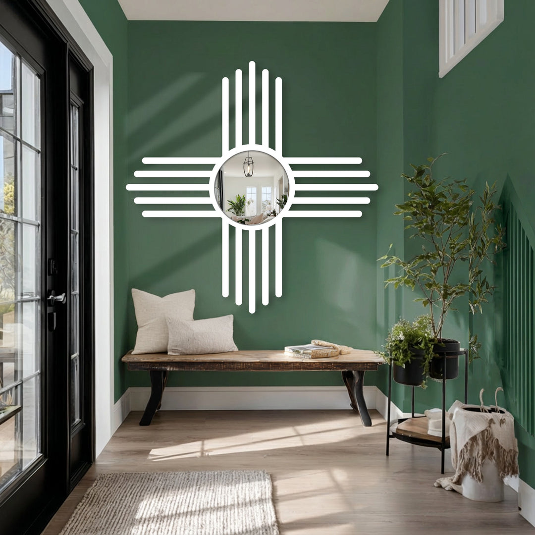Reflecting an interior space, the round modern mirror is the focal point, surrounded by a white cross line design that draws the eye.