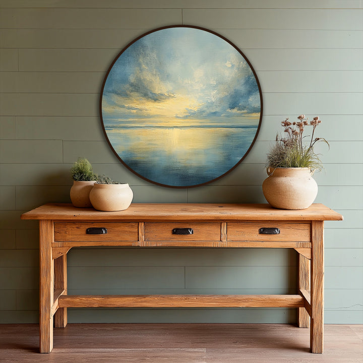 Highlighted by its dramatic circular frame, this oil painting reproduction print of a serene sea horizon captures golden light reflecting on still waters.