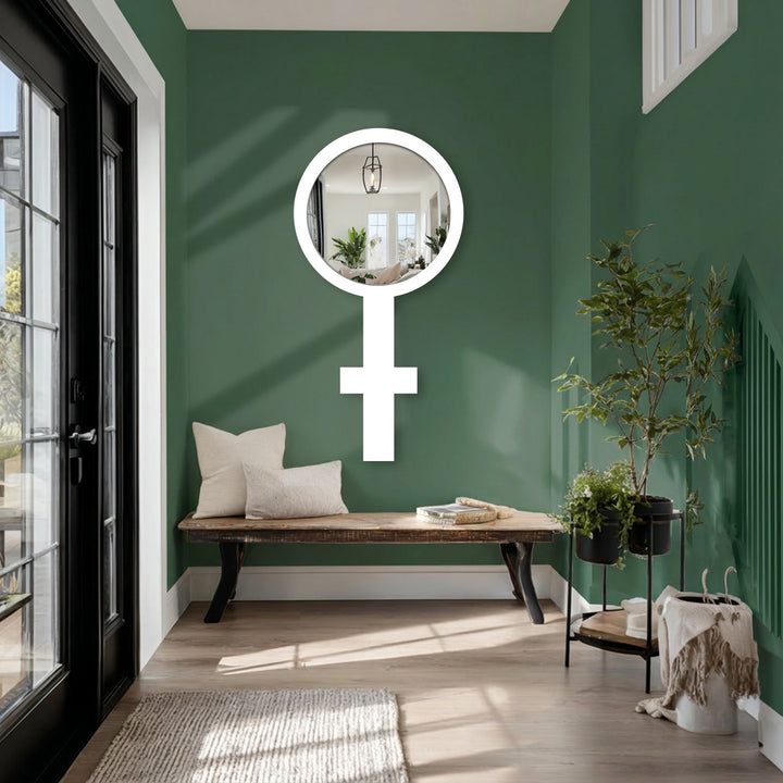 Illuminating the foyer, the oversized decorative mirror fashioned into a Venus symbol becomes the loudest element, reflecting light and adding a modern touch to the space.