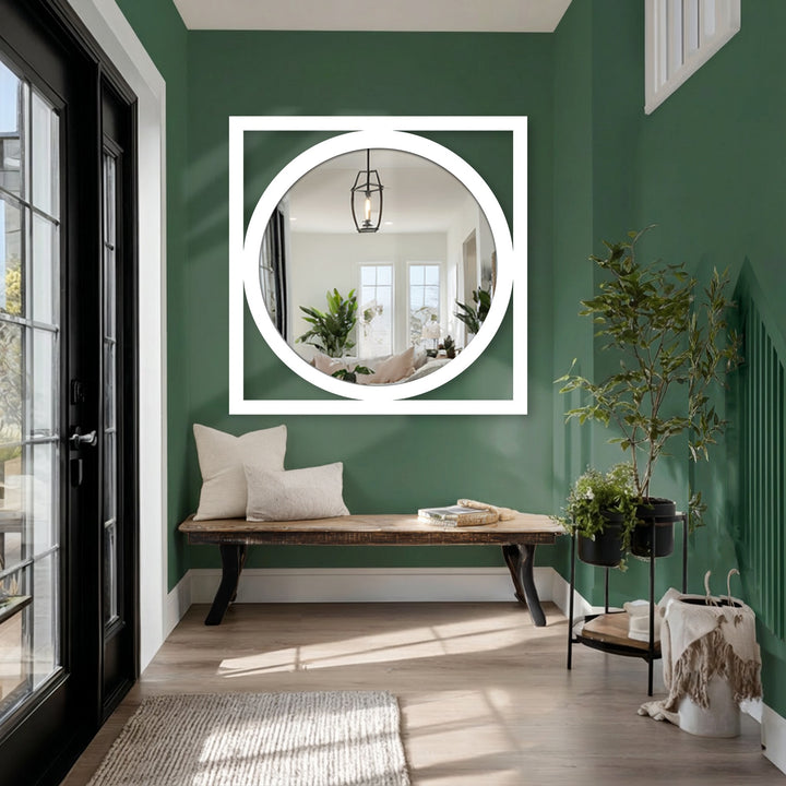 Contrasting hues highlight the square framed round mirror for wall decor, offering a stark visual against the deep green backdrop in a modern entryway.