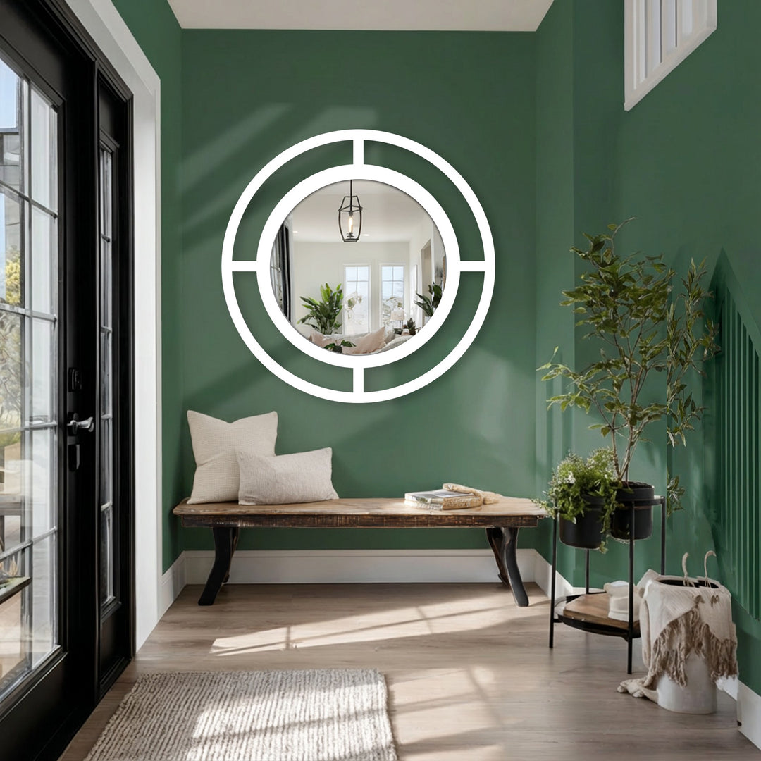 With its high color saturation, a modern wall mirrors creates a striking focal point amidst the saturated green hues of the surrounding interior.