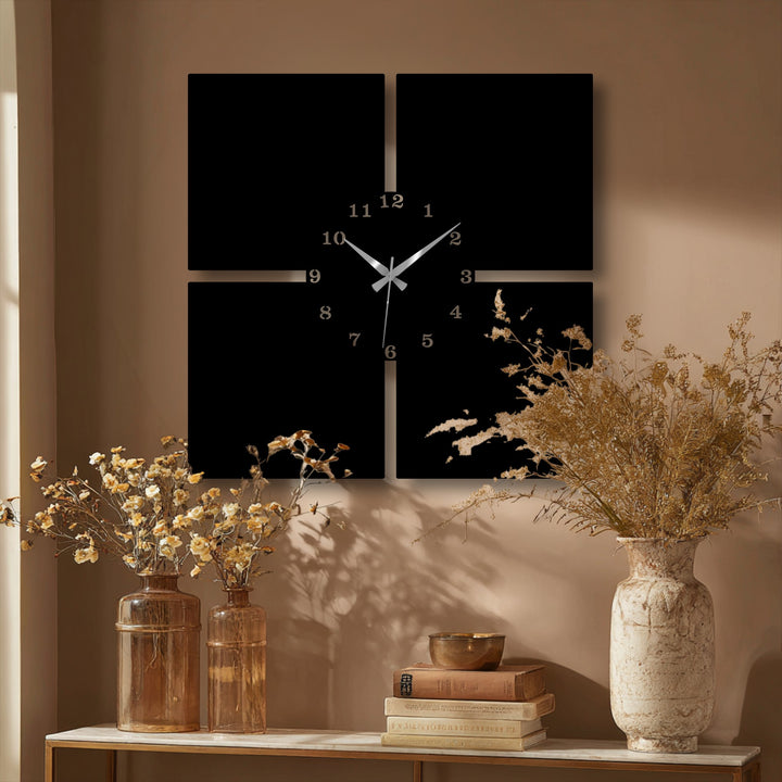 Delicate dried floral arrangements gracefully soften the rigid lines of the minimal 4-piece metal wall clock, creating a harmonious metal wall decor.