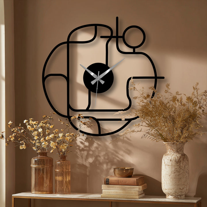 Captured in the stillness, the abstract continuous line modern metal wall clock stands as an elegant decoration wall art piece against a calm, muted backdrop.