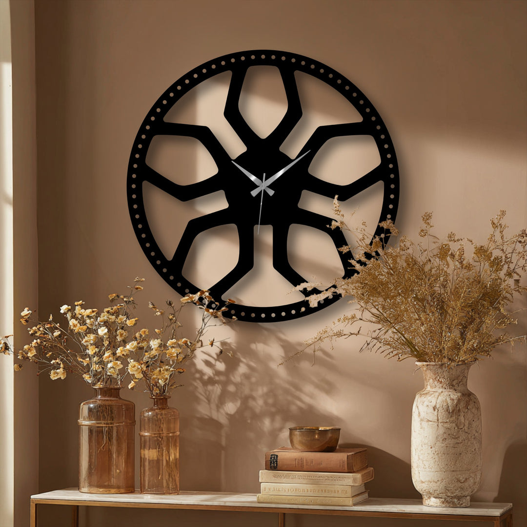 The focal point is a large, modern black abstract radial pattern metal wall clock, an elegant decoration wall art piece.
