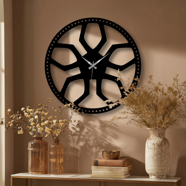 The focal point is a large, modern black abstract radial pattern metal wall clock, an elegant decoration wall art piece.