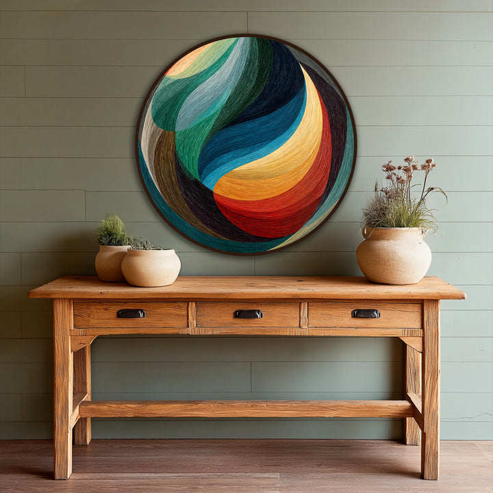 Foreground shows a distressed wood table with ceramic pots beneath a vibrant Chromatic Flow modern abstract oil painting reproduction print.