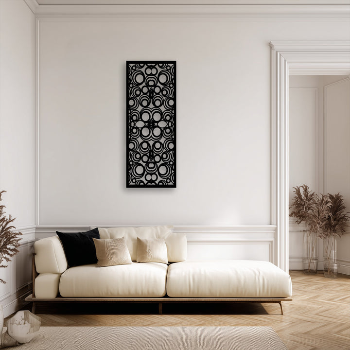 The sleek matte black finish of the decorative metal art with intricate geometric circles enhances the modern abstract panel's sophisticated design.