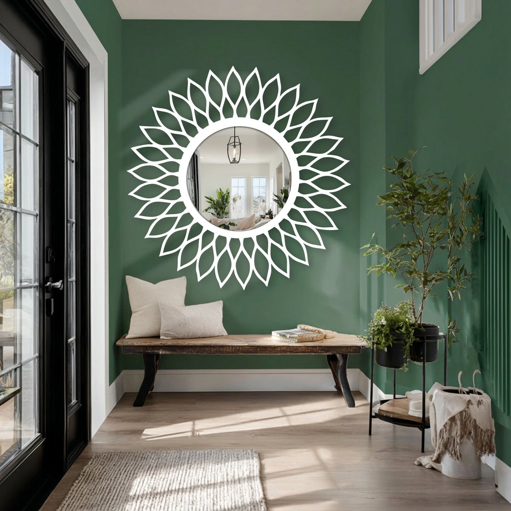 Green-painted background contrasts with the radiant leaf halo floor mirror, complementing the decorative metal art style.