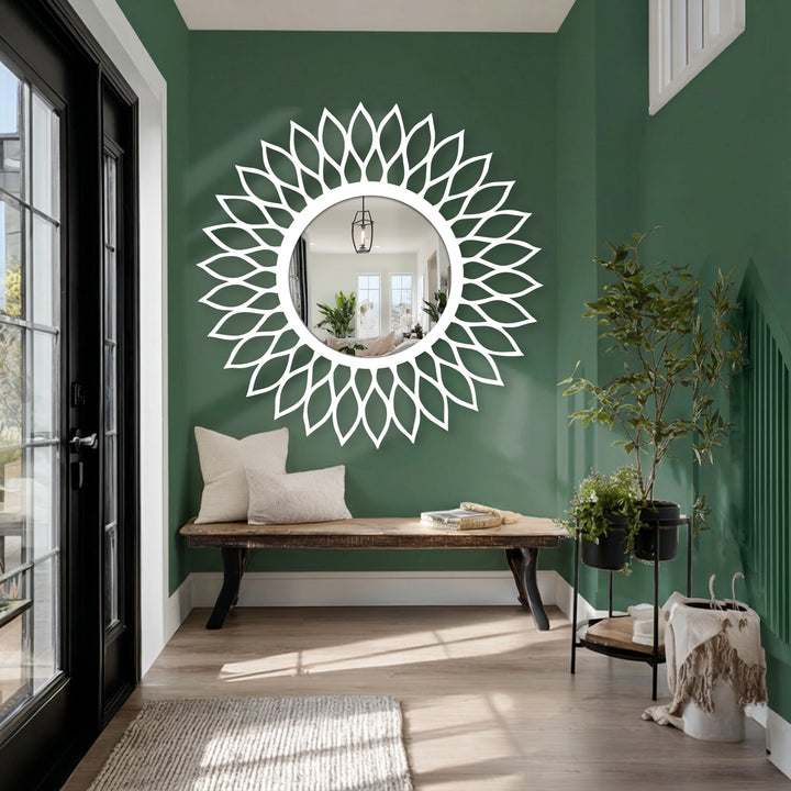 Green-painted background contrasts with the radiant leaf halo floor mirror, complementing the decorative metal art style.