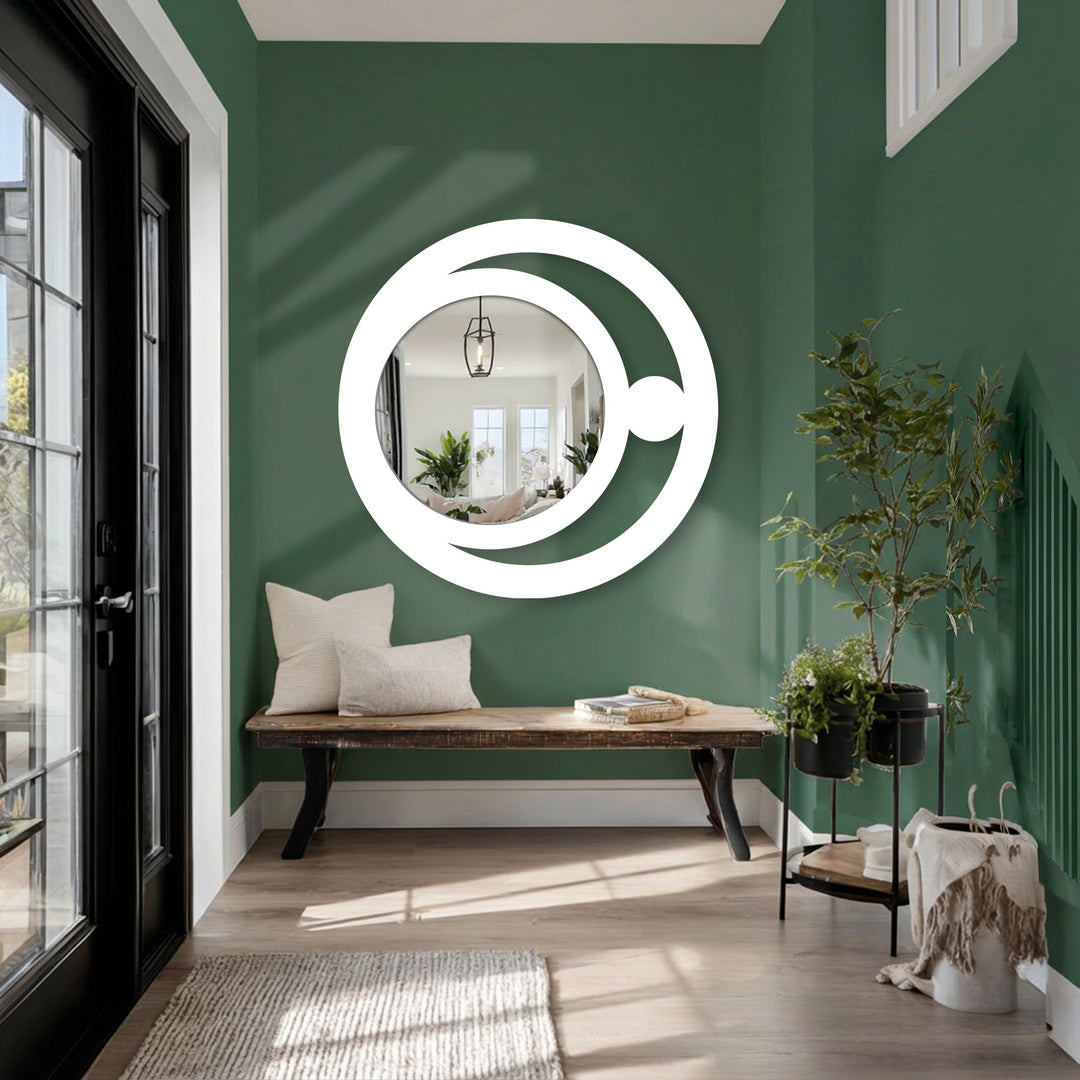 Horizontal modern wall mirrors featuring a circular shape with a crescent orb design, offering a unique metal wall art piece.