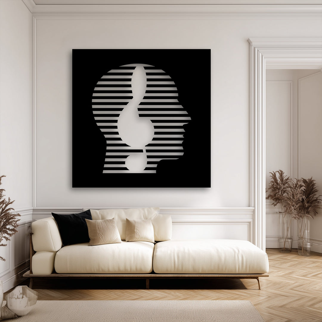 A striking metal wall decor piece reveals an abstract face formed by shimmering striped layers, creating visual depth against its black background.