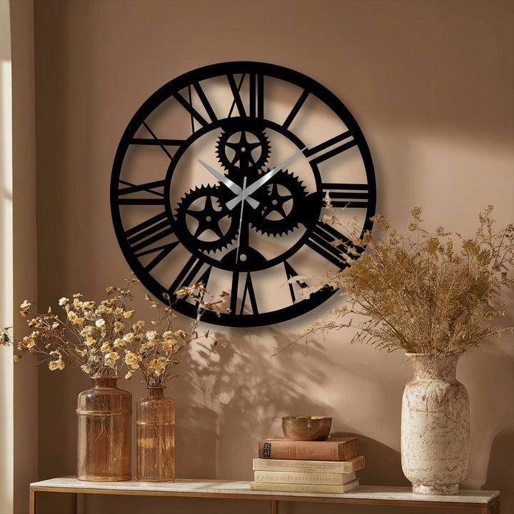Surface texture shows a smooth, dark sheen over the industrial gear design on this distinctive, unique modern wall decor clock crafted from metal with visible roman numerals.