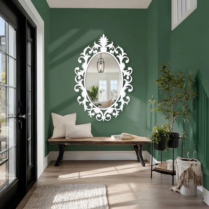 Featuring a lush green wall as the backdrop for a decorative oval floor mirror, demonstrating how decorating with wall mirrors can enhance a room's aesthetic.