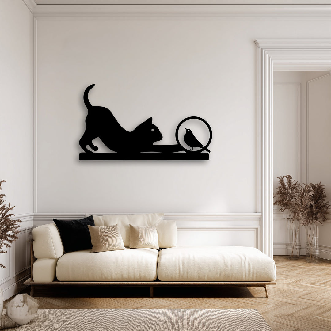 The striking color contrast highlights the black playful cat and curious bird silhouette metal art for wall against the bright white wall.