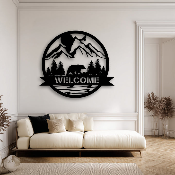 The intricate layering of the black metal wall decor creates striking depth, featuring a mountain bear welcome sign against a nature landscape.