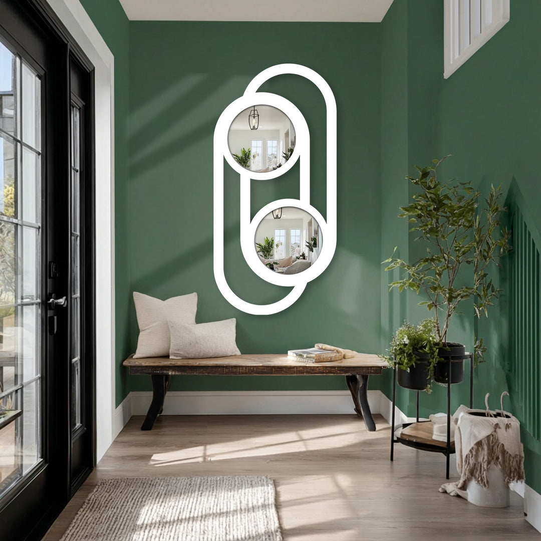 Focusing on the realistic detail, the double circle link metal wall mirror showcases intricate metal artwork in a modern, minimalist design, reflecting the home decoration within its mirrored surfaces.