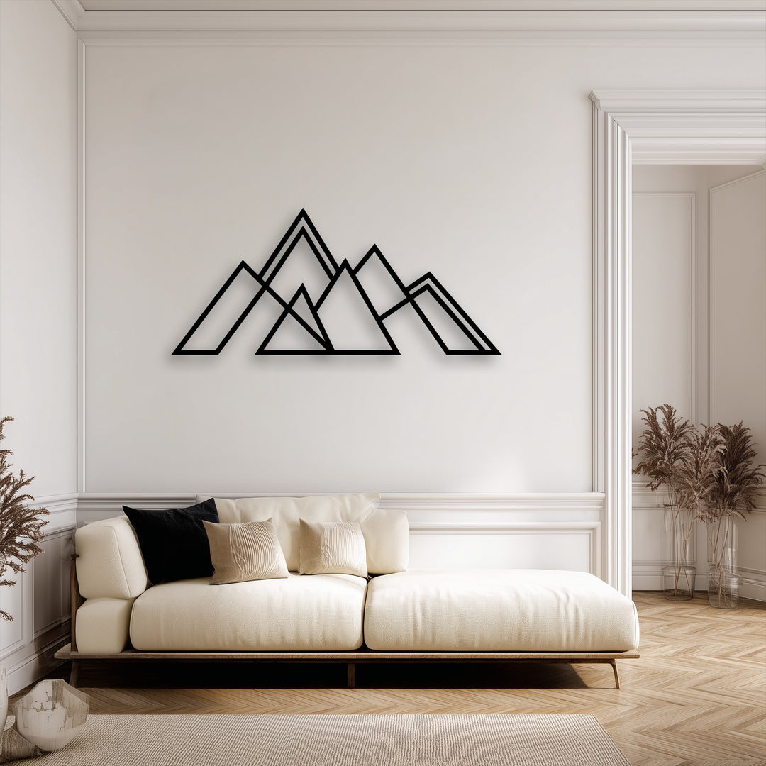The crisp edges of the geometric mountain metal wall decor harmonize with the room's elegant wall molding and door frame borders.