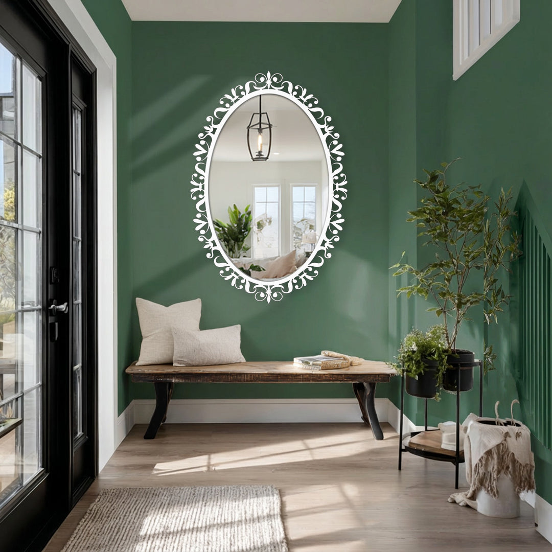 Vertically oriented oval framed wall mirror featuring ornate floral scrollwork adds a touch of elegance to any space with its unique shape.