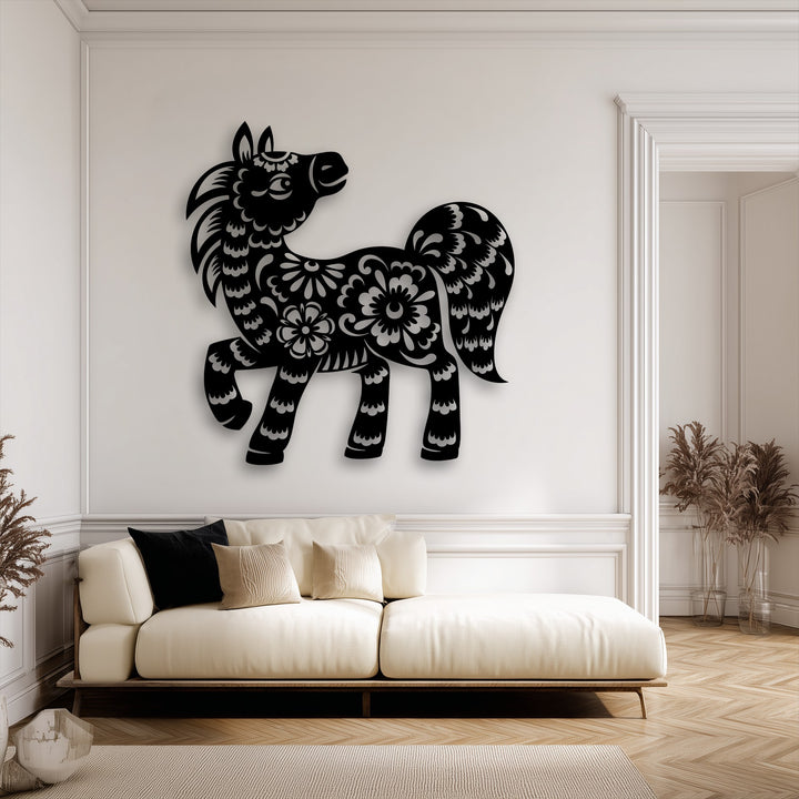 The stillness of the room is enhanced by the elegant black floral pony unique metal wall art hanging above a cream sofa.