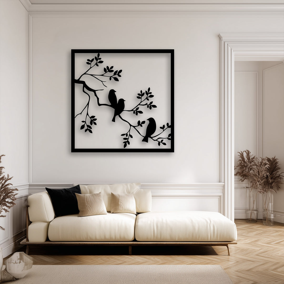 The visual rhythm of the stylized branches and birds within the unique metal wall art creates a harmonious flow above the contemporary sofa, enhancing the decor.