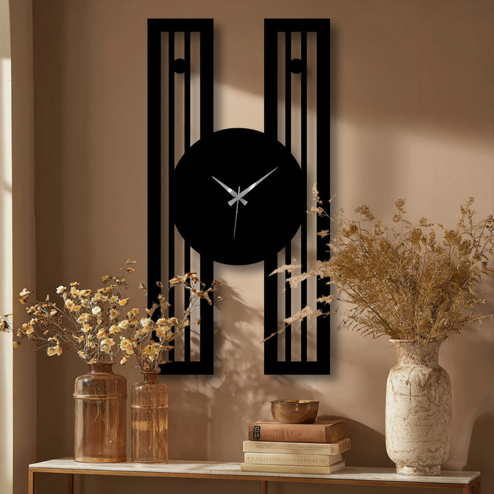 Arranged with striking depth and layers, a modern geometric frame highlights the vertical metal wall clock, offering captivating metal wall decor against a neutral backdrop.