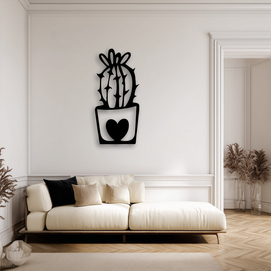 The negative space around the cute cactus decorative metal art with a heart pot design creates a striking silhouette on the minimalist wall.