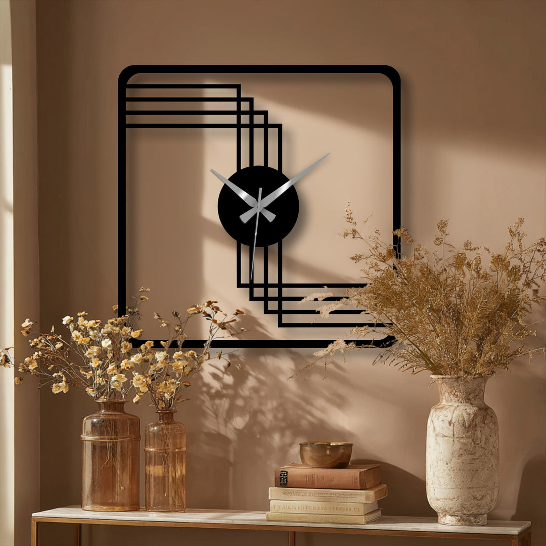 Framing the time, the negative space defines the minimalist design of this square geometric metal wall clock, a piece of unique metal wall art.