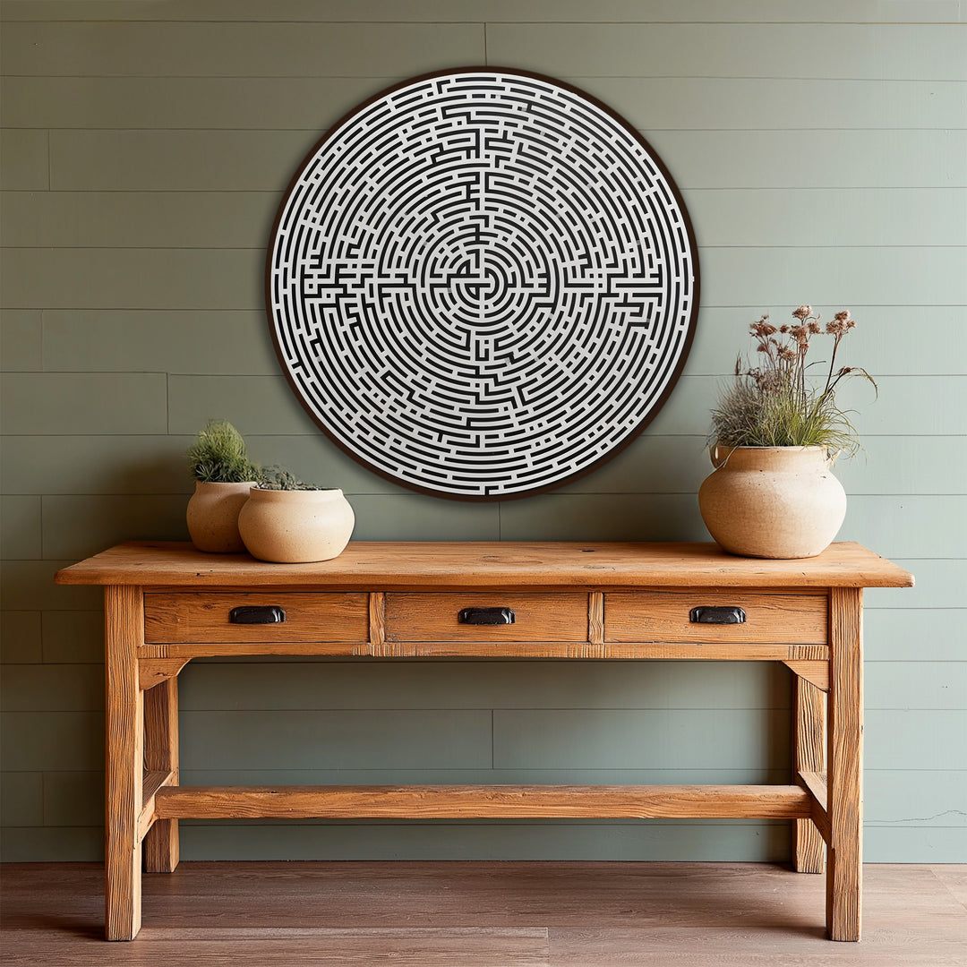 Interlocking layers of black and white in this oil painting wall art create depth in a minimalist round labyrinth design on wood.