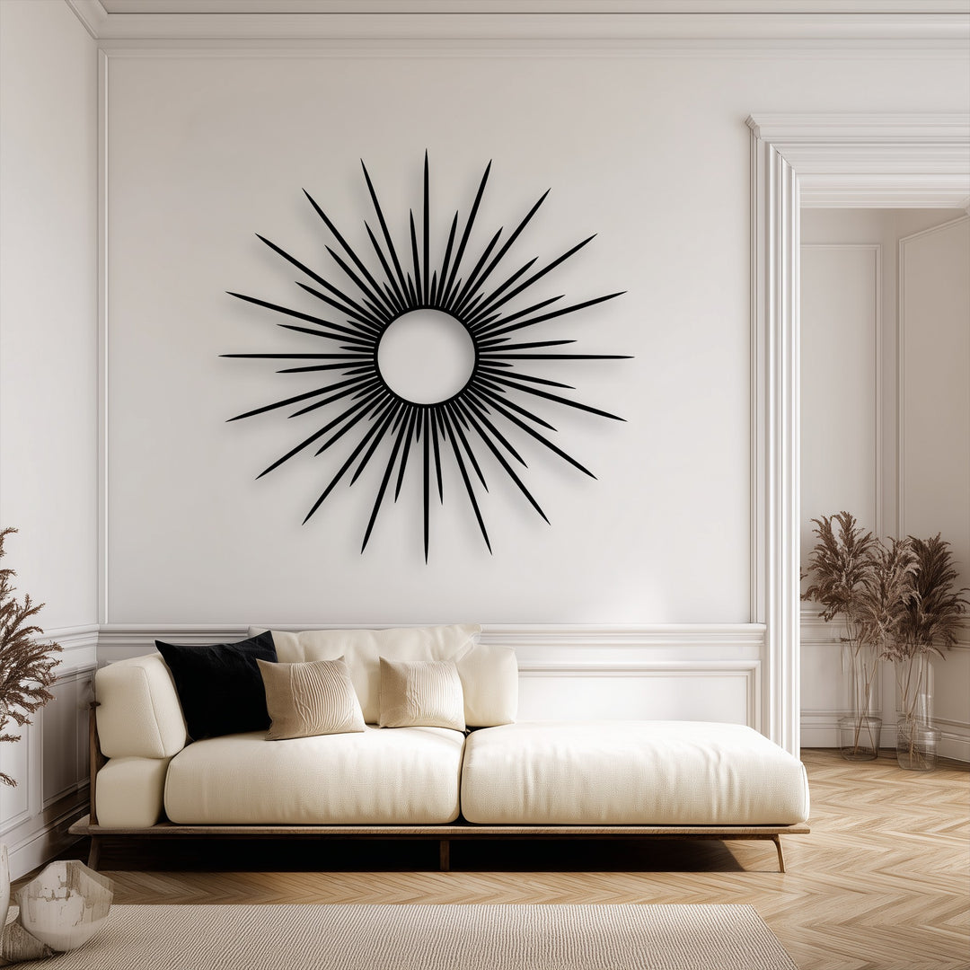 A horizontally expansive, circular decorative metal art in a radiant sunburst shape hangs above a cream sofa.