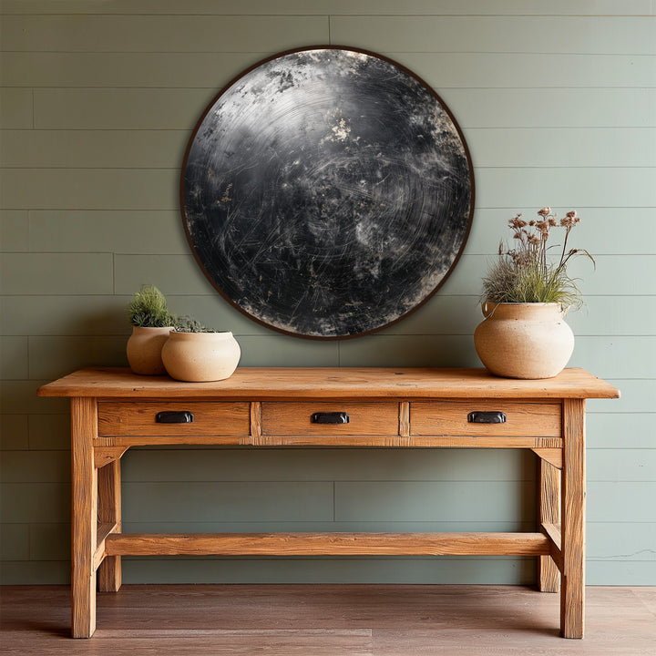 The darkest area of the midnight orbit abstract round wooden oil painting decoration exhibits a scratched texture, contrasting against the table below.