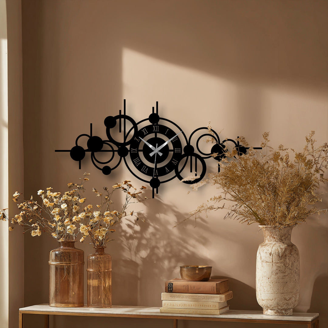 Calming and neutral, this scene features an abstract circle orbit metal wall clock, a piece of metal art for wall, complemented by dried flower arrangements and stacked books.