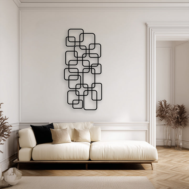 The stillness of this elegant room is framed by the black geometric metal wall art, a compelling decoration wall art above the cream sofa.