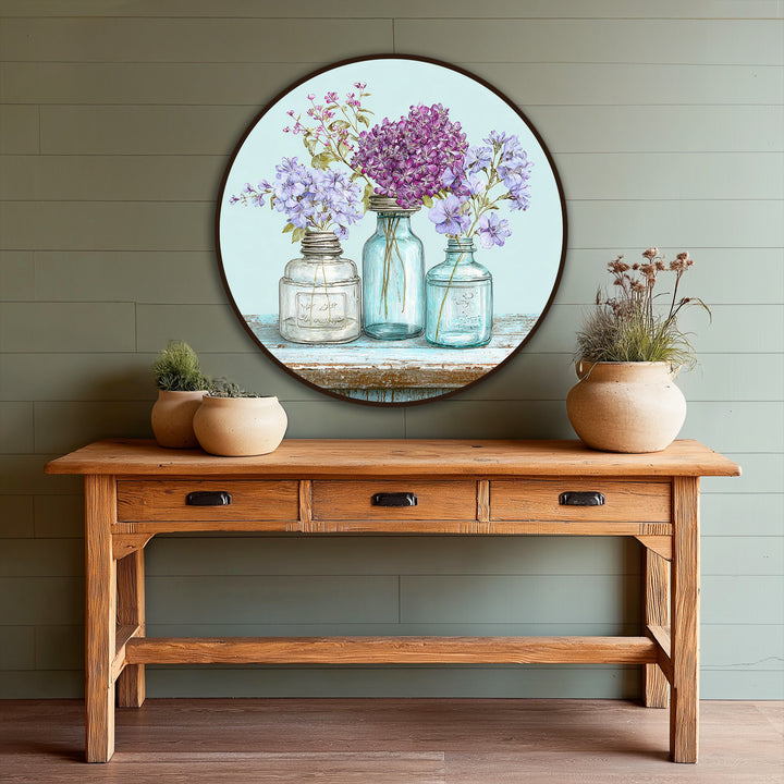 Round oil painting home decor piece showcases a charming pastel wildflower arrangement in vintage-style jars, creating a vibrant yet calming presence as the loudest element.