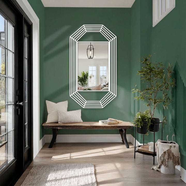 Three parallel white lines create the octagonal edge and borders of this framed wall mirror, offering a striking contrast to the modern green space.