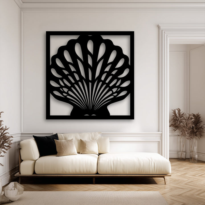 Striking color contrast highlights this elegant black seashell frame metal artwork against a bright, minimalist white wall.
