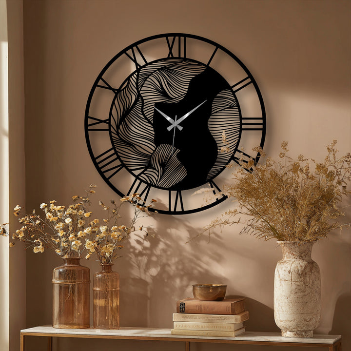 The darkest area within the abstract wave patterns of this metal wall clock contrasts beautifully with the surrounding metal artwork, offering a striking modern touch.