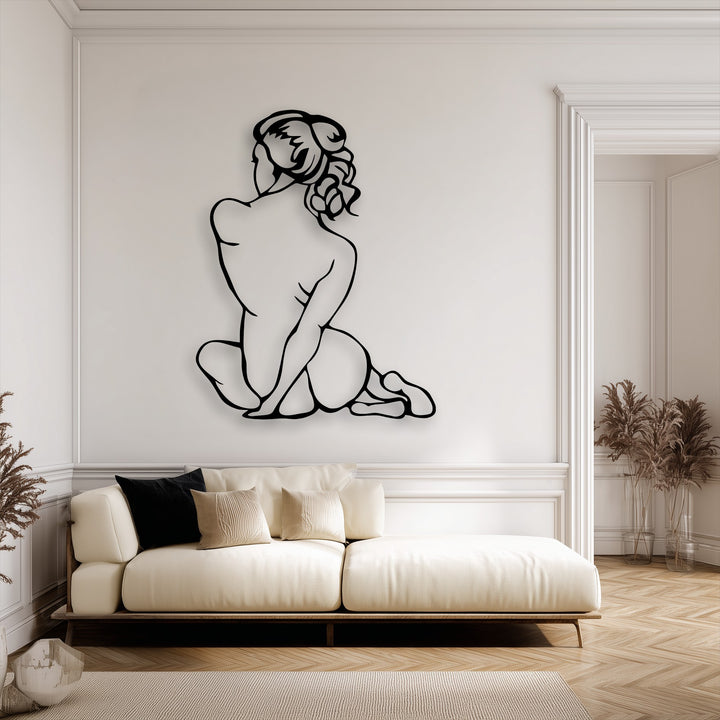 The sleek matte black finish of the decorative metal art creates a striking minimalist outline of a female figure.