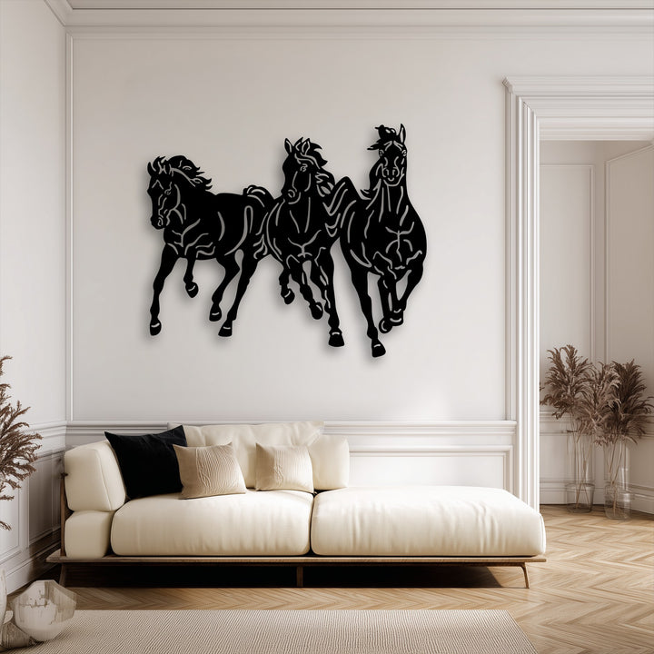 Plush white sofa cushions and soft pillows provide luxurious comfort beneath striking metal wall decor of galloping trio horses.