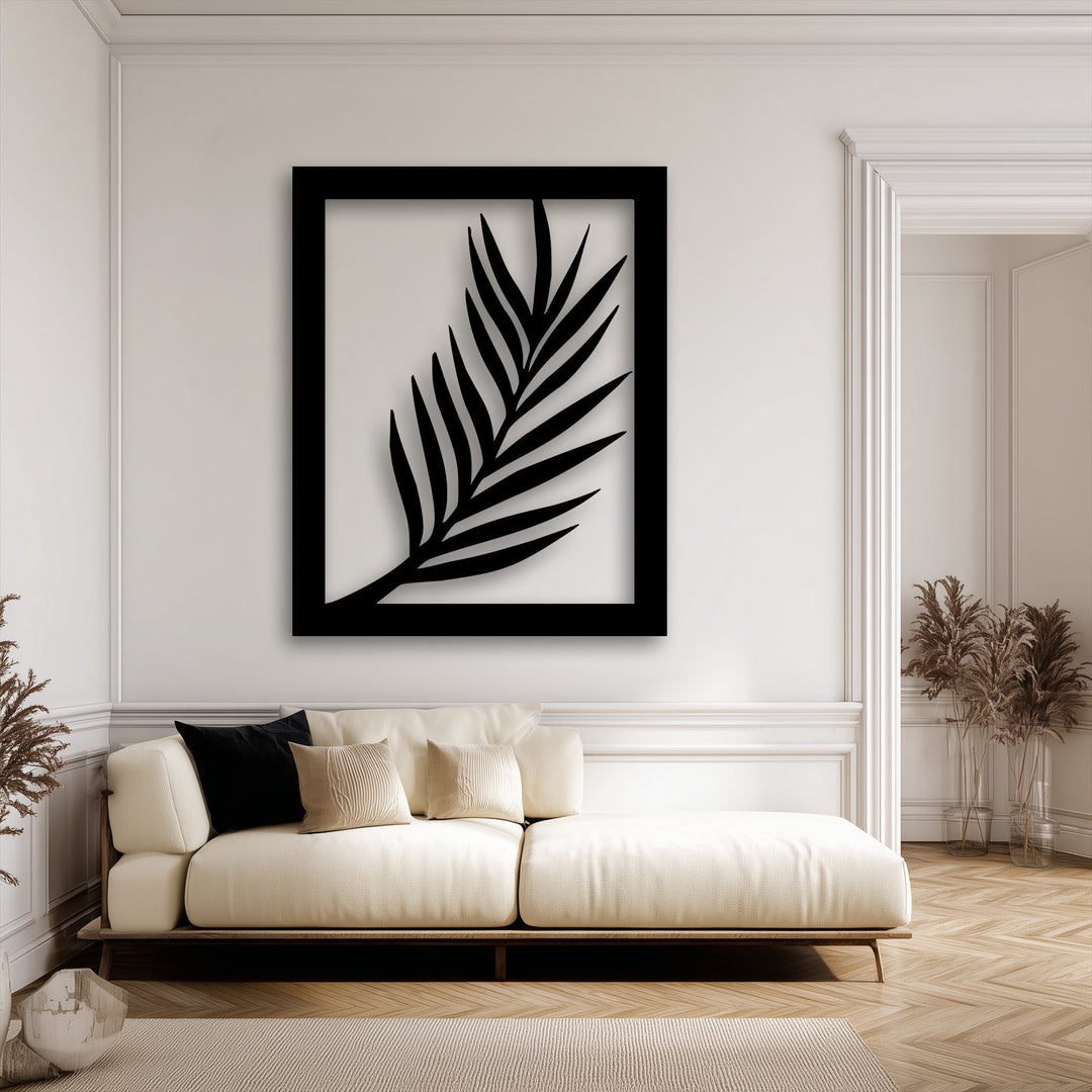 The visual rhythm of the elegant black palm leaf metal artwork creates a soothing, modern botanical focal point above a cream sofa.
