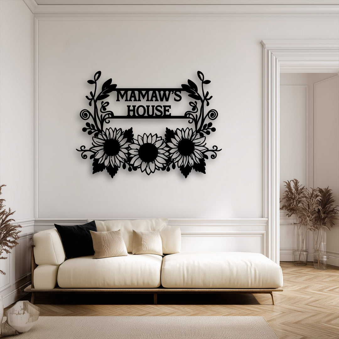The inviting mood of a warm home is enhanced by personalized sunflower family name metal decoration wall art over a cozy sofa.