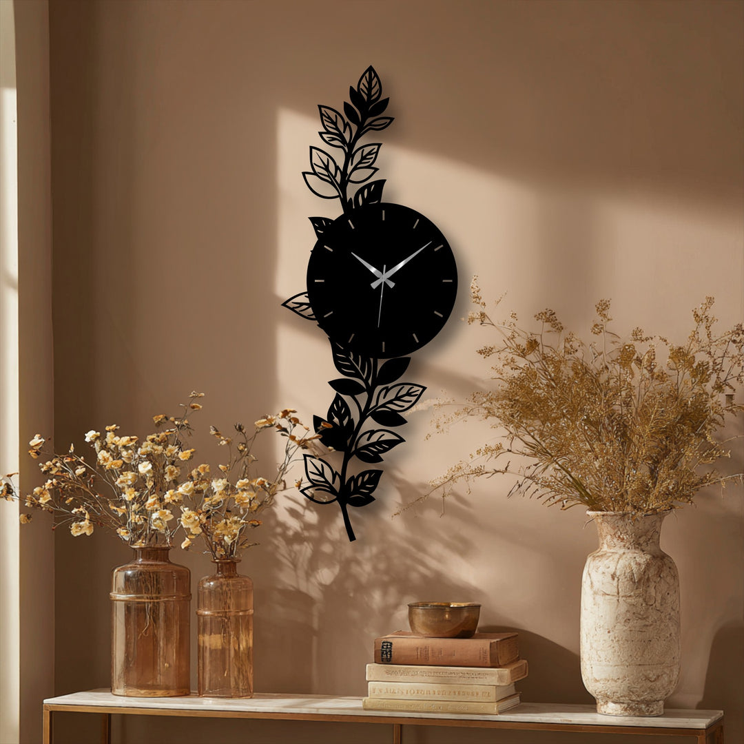 Vertical botanical leaf metal wall clock showcases an artistic orientation and round shape, offering a striking decoration wall art piece for modern interiors.